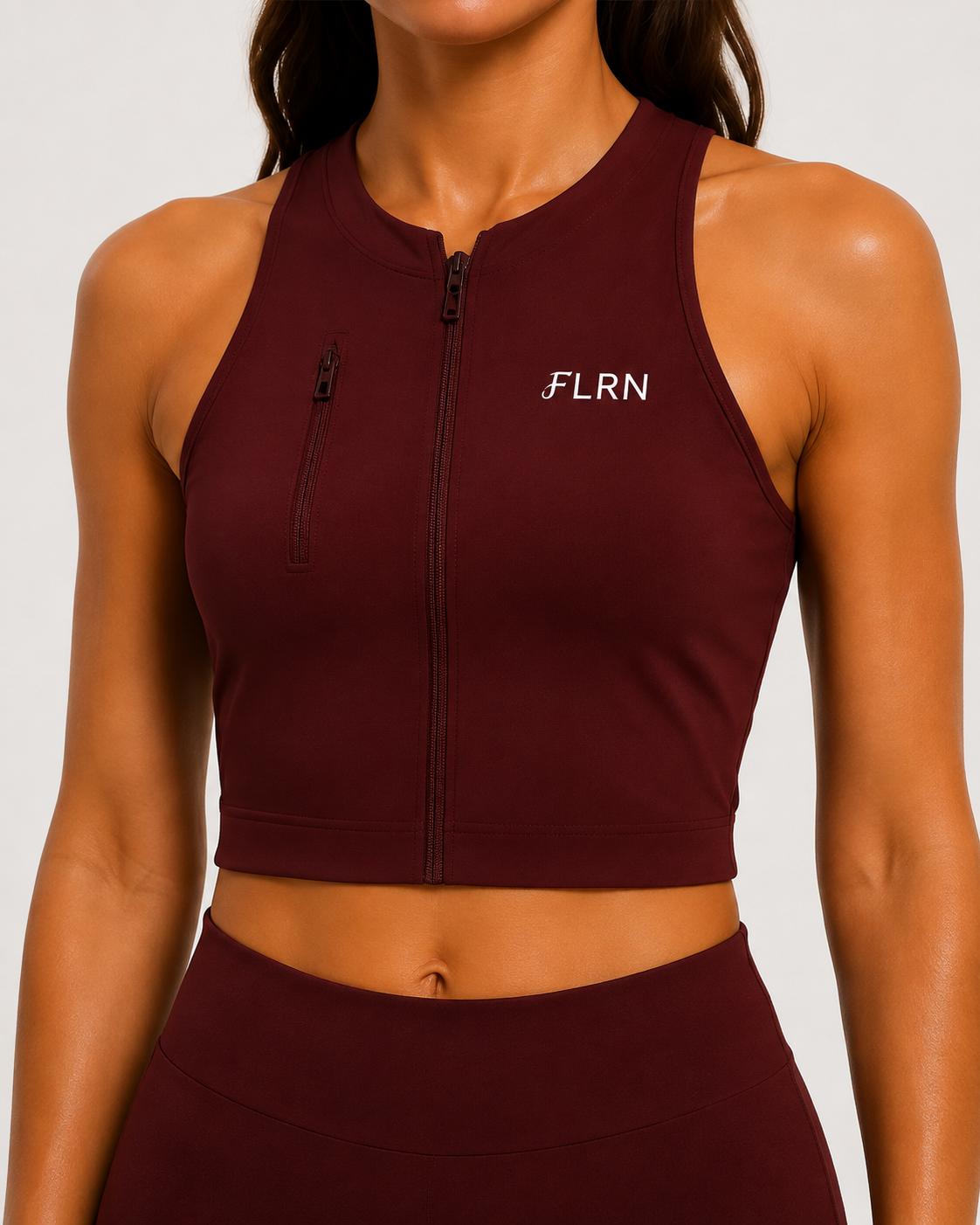 Front view of the FLRN Performance Top with front zip and zipped chest pocket